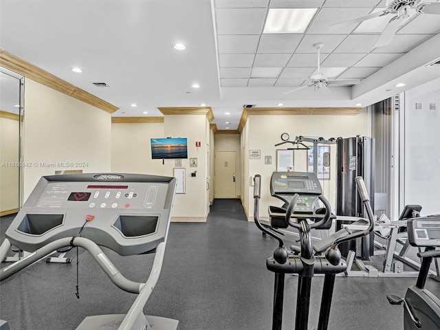 exercise room with crown molding, a drop ceiling, and ceiling fan