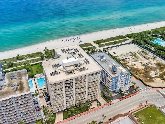 drone / aerial view with a water view and a beach view