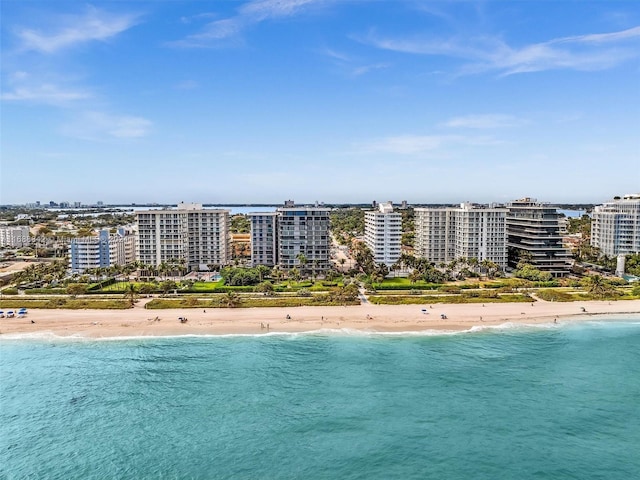 drone / aerial view with a water view and a beach view