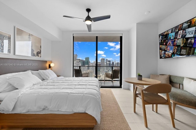 tiled bedroom with access to outside, ceiling fan, and a wall of windows