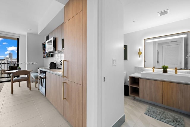 kitchen featuring light tile patterned floors and floor to ceiling windows