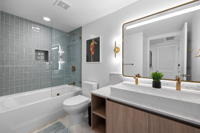 full bathroom with tiled shower / bath, vanity, toilet, and tile patterned floors