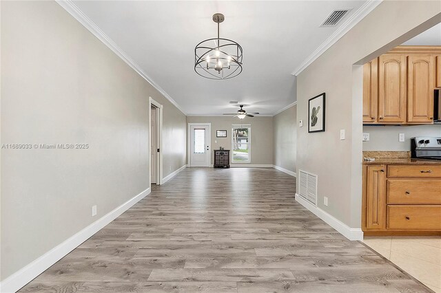 hall with light hardwood / wood-style flooring, an inviting chandelier, and crown molding