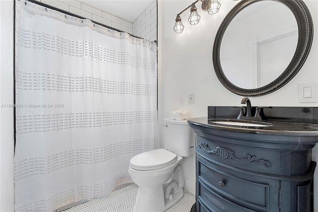 bathroom with vanity, a shower with shower curtain, and toilet