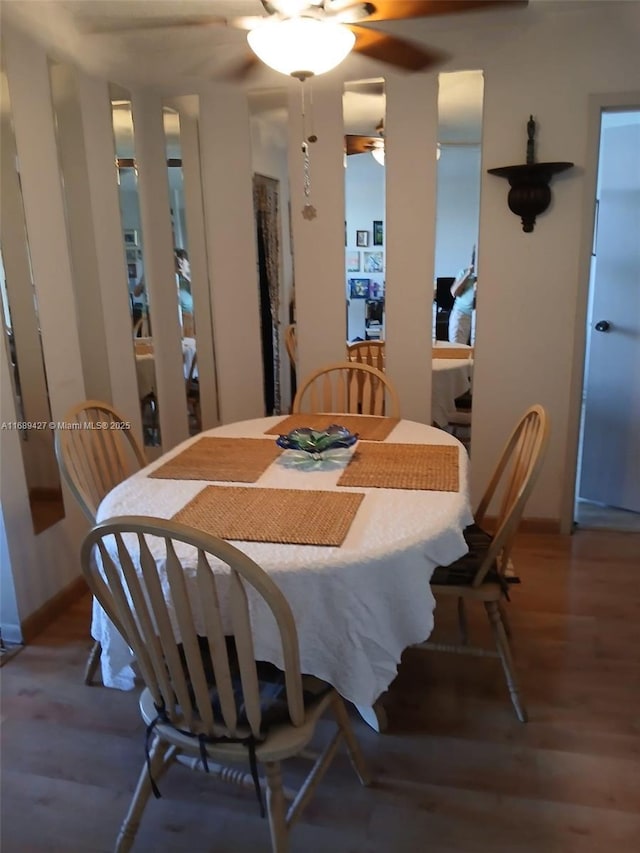 dining space with hardwood / wood-style flooring and ceiling fan