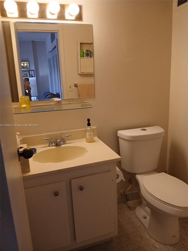 bathroom with vanity, tile patterned flooring, and toilet