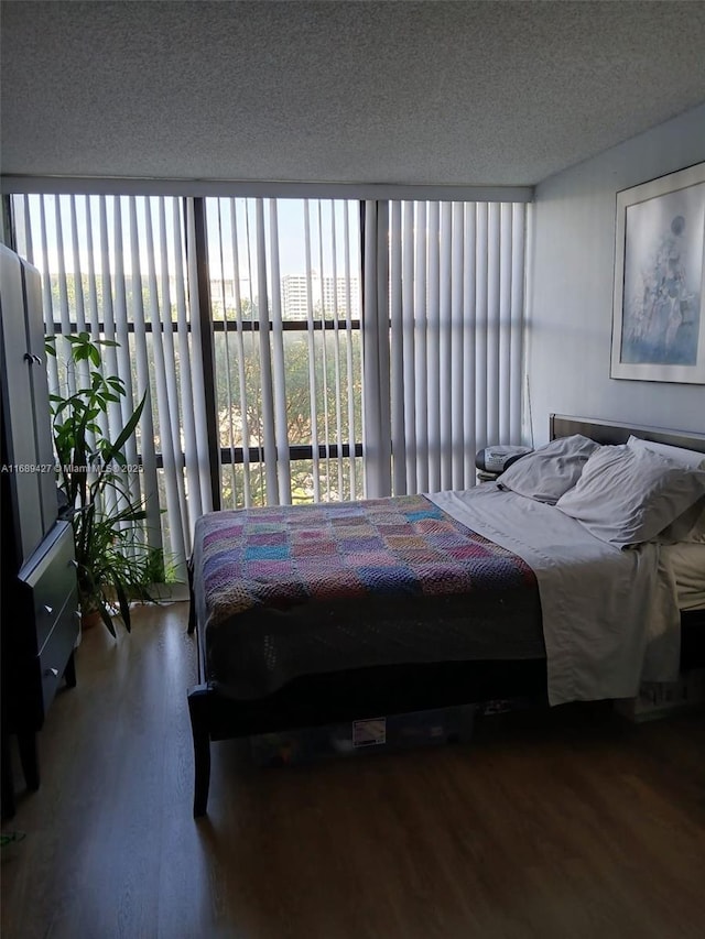 bedroom with wood-type flooring and a textured ceiling