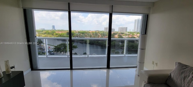 doorway to outside featuring tile patterned flooring and a water view