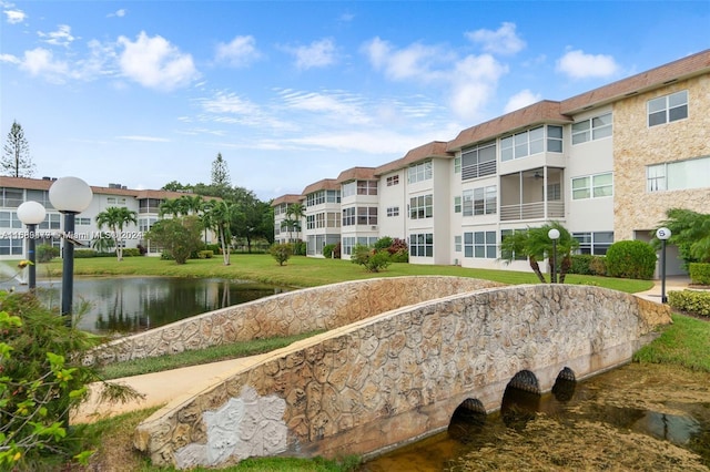 view of home's community featuring a water view and a yard