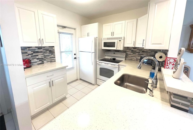 kitchen featuring white cabinets, white appliances, sink, and tasteful backsplash