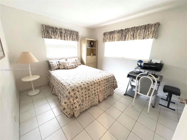 tiled bedroom featuring multiple windows