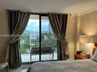 bedroom featuring expansive windows and crown molding