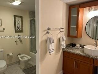 bathroom with an enclosed shower, vanity, and toilet