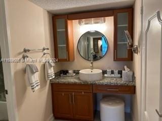 bathroom featuring vanity and a textured ceiling