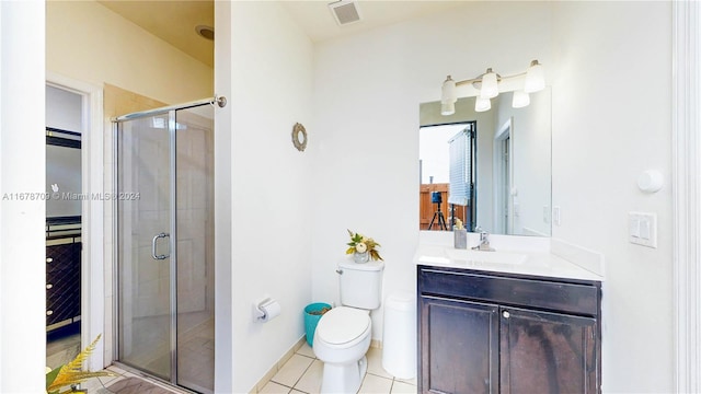 bathroom with vanity, walk in shower, tile patterned flooring, and toilet