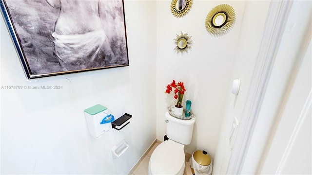 bathroom with toilet and tile patterned flooring