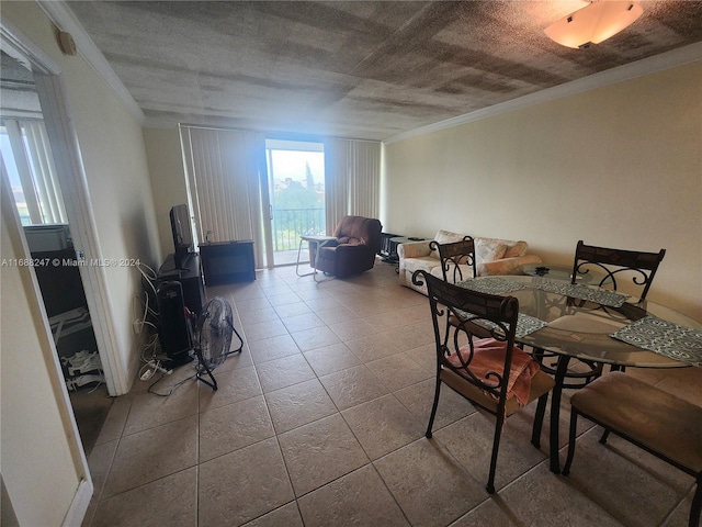 dining area featuring crown molding, a textured ceiling, and tile patterned floors