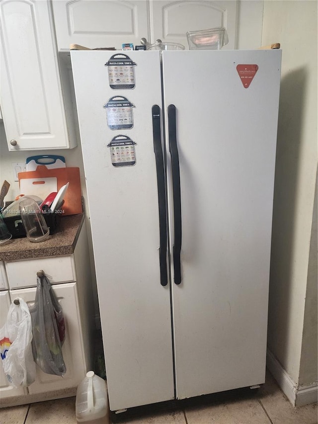 room details with white cabinets and white refrigerator