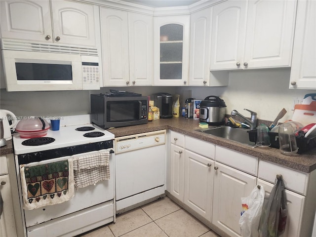 kitchen featuring white cabinetry, white appliances, sink, and light tile patterned floors