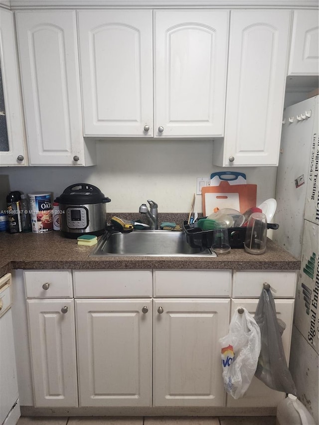 kitchen with white cabinets, white appliances, and sink