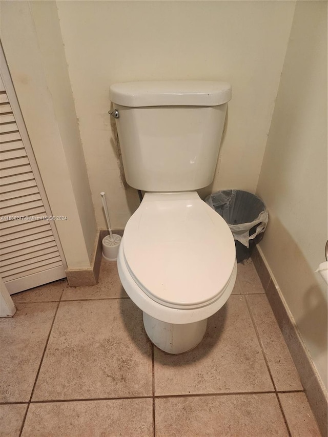 bathroom with toilet and tile patterned flooring