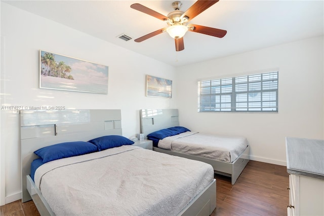 bedroom with ceiling fan and dark hardwood / wood-style floors