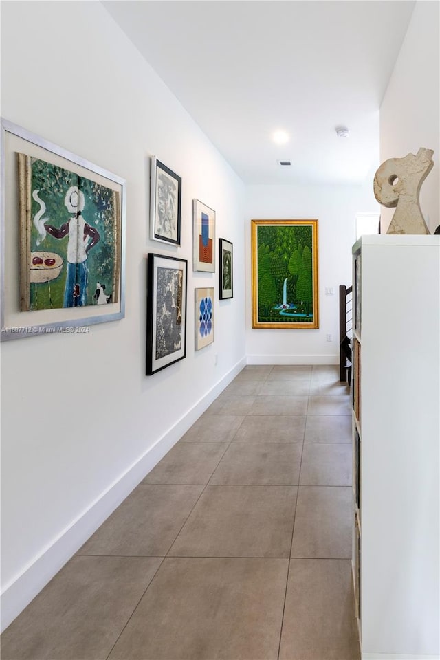 corridor featuring light tile patterned floors