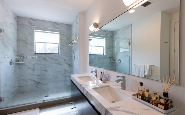 bathroom featuring a wealth of natural light, vanity, and an enclosed shower