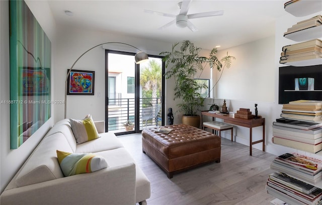 living room featuring hardwood / wood-style floors and ceiling fan