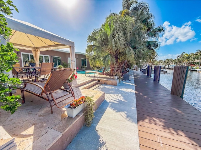 view of patio featuring a water view and a boat dock