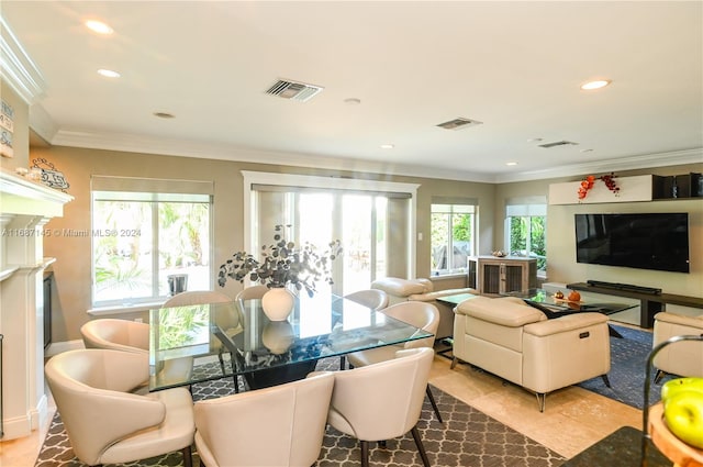 dining room with plenty of natural light and ornamental molding