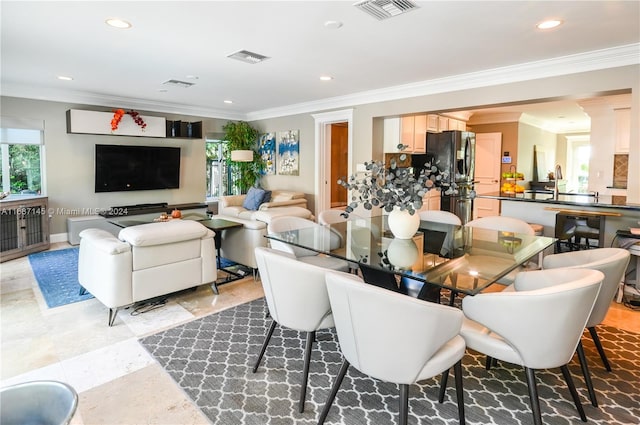 dining space with ornamental molding