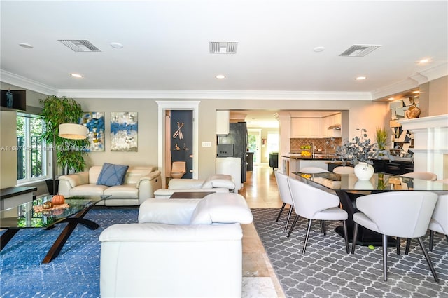 living room with a wealth of natural light and crown molding