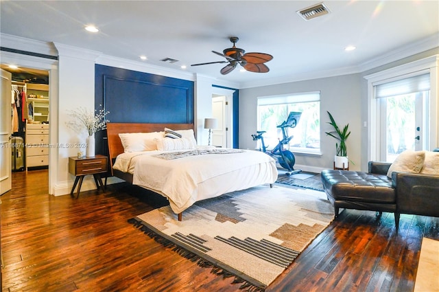 bedroom featuring dark hardwood / wood-style flooring, ornamental molding, and ceiling fan