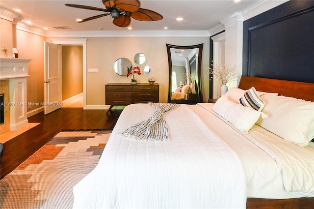 bedroom featuring ornamental molding, dark wood-type flooring, and ceiling fan