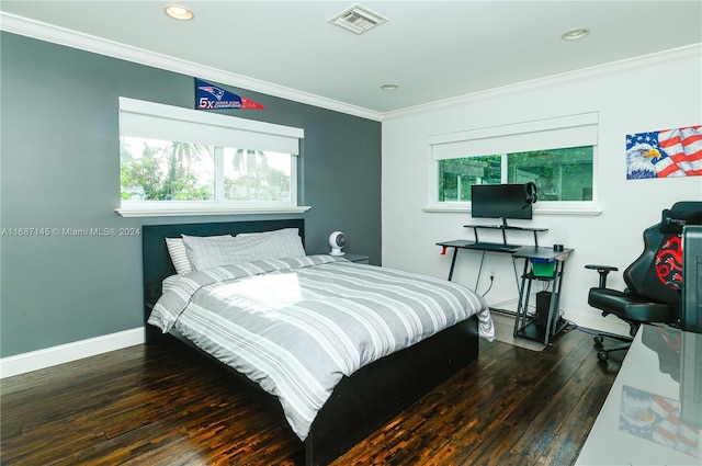 bedroom with ornamental molding, multiple windows, and dark hardwood / wood-style floors