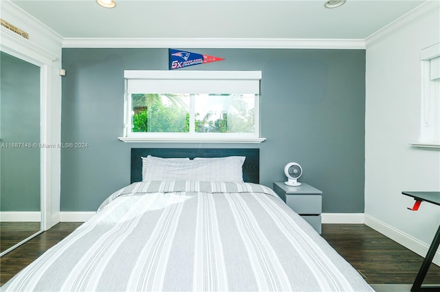 bedroom with ornamental molding, a closet, and dark hardwood / wood-style floors