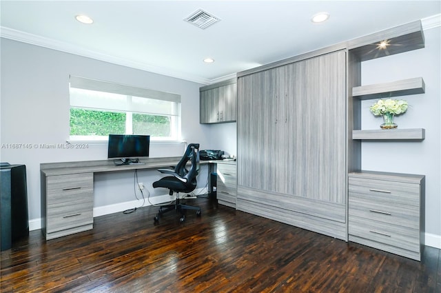 office area featuring dark hardwood / wood-style flooring, built in desk, and crown molding