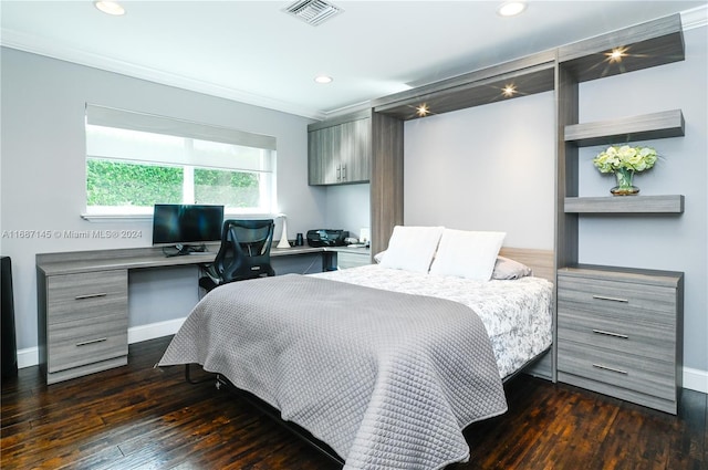 bedroom with dark wood-type flooring, built in desk, and ornamental molding