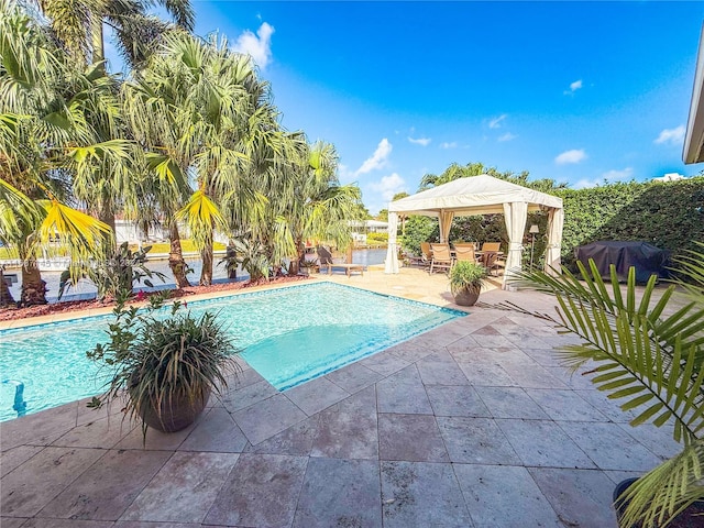 view of pool featuring a patio, a gazebo, and a grill