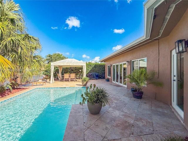 view of swimming pool featuring a patio and a gazebo