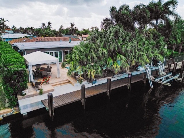 dock area featuring a patio, a water view, and a gazebo