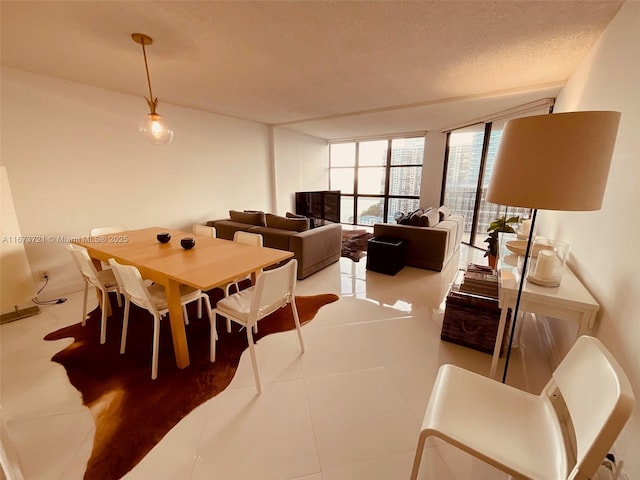 tiled dining space with a wall of windows and a textured ceiling