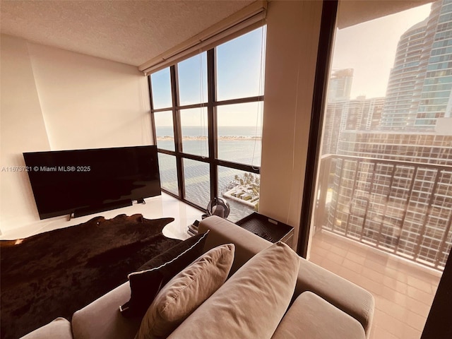 living room featuring floor to ceiling windows and a textured ceiling