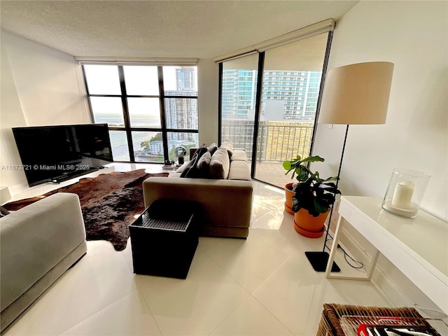 tiled living room with a textured ceiling and a wall of windows