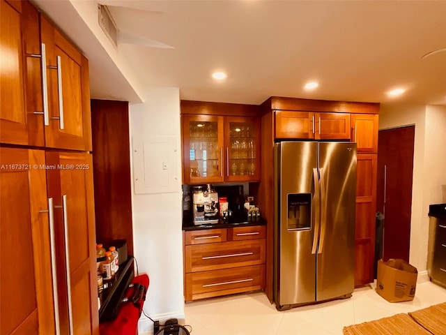 kitchen with light tile patterned flooring, stainless steel fridge, and electric panel