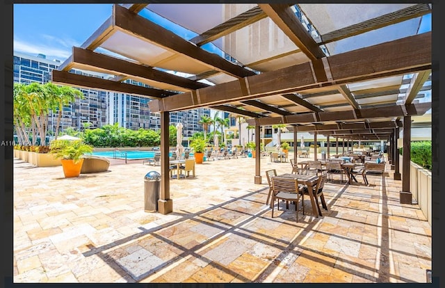 view of patio / terrace with a community pool and a pergola