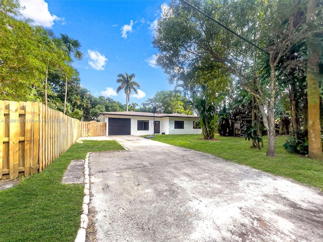 view of front facade featuring a garage and a front lawn