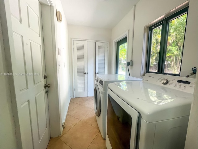 laundry room with light tile patterned flooring and independent washer and dryer