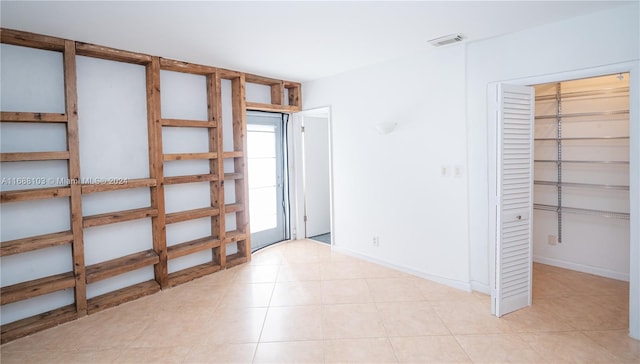 empty room with light tile patterned floors